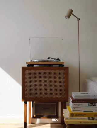 SAMBA wood and cane record player cabinet with a speaker on the lower shelf.