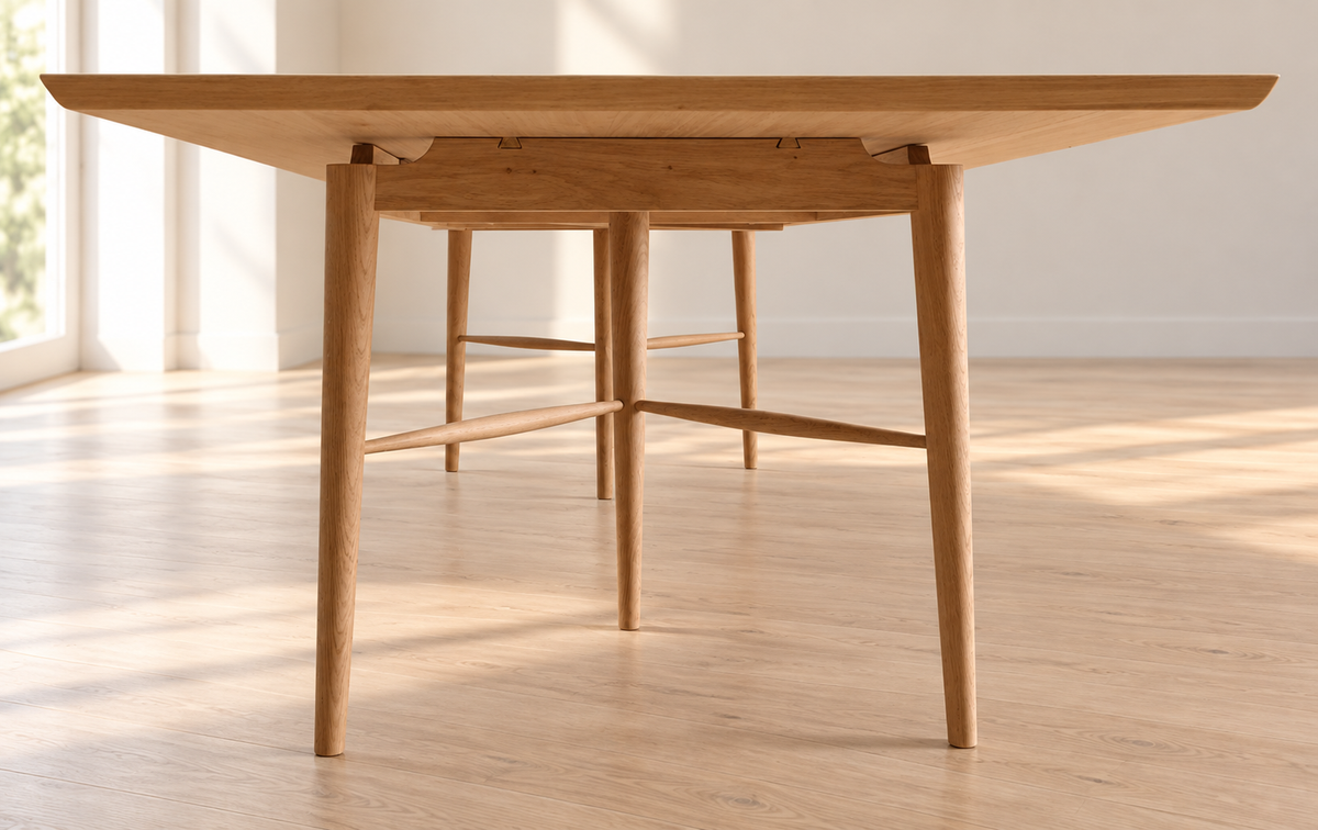 Detail of the turned legs and V-shaped stretchers of the GLEVA dining table.