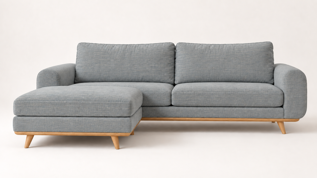 Three-quarter view of the LOTO sofa in Slate Blue with a wooden base.